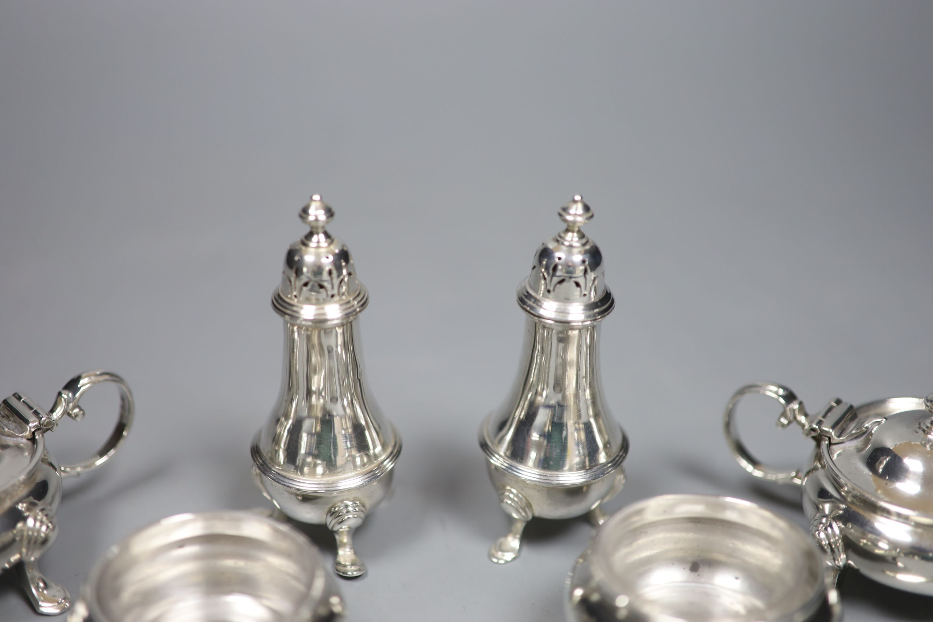 A silver six-piece condiment set, with spoons, Goldsmiths & Silversmiths Co Ltd, London, 1923/4/5 and a silver napkin ring.